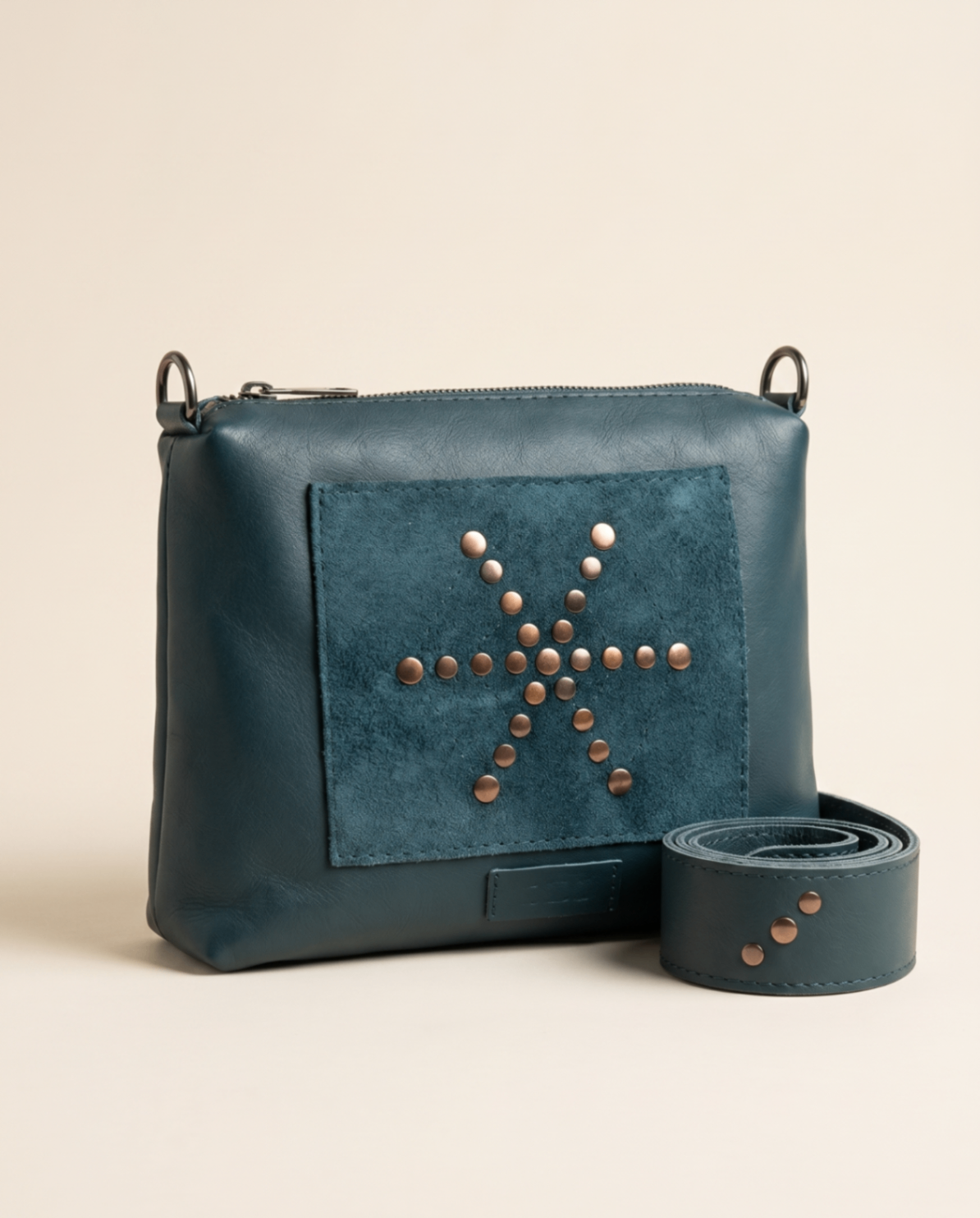 Petroleum blue leather clutch with a studded motif panel and matching strap.