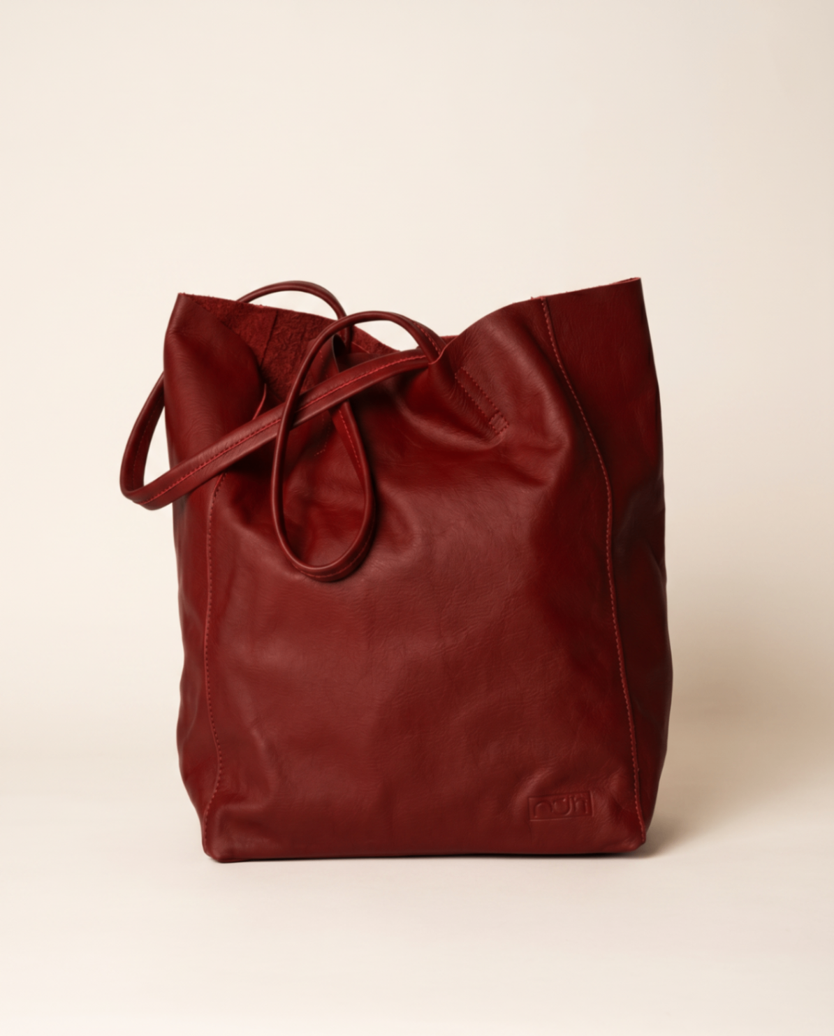 Soft burgundy leather tote with slim shoulder straps.