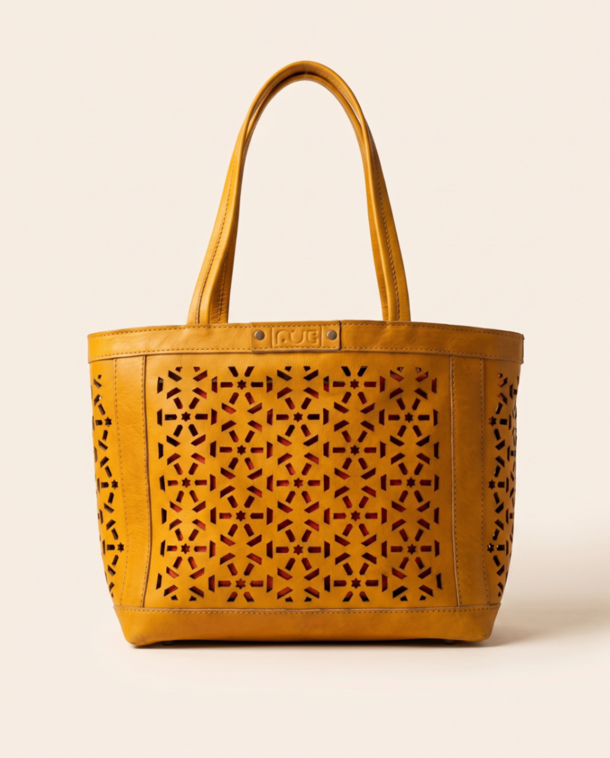 Yellow leather tote with mashrabiya cutwork panels.